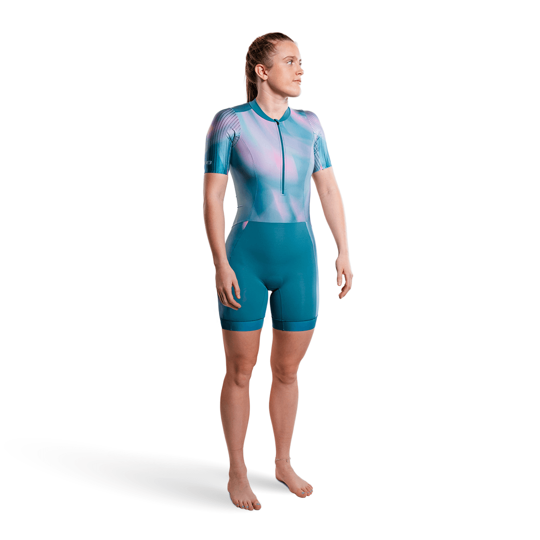 Person wearing a teal and pink trisuit on a white background