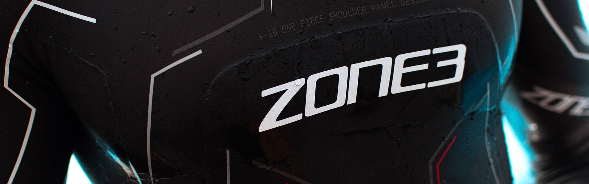 Close up of a black Zone3 wetsuit with the white Zone3 logo and water droplets