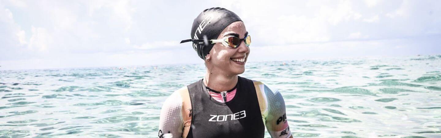 Norma Coker is running on the road in her ZONE3 pro team trisuit 