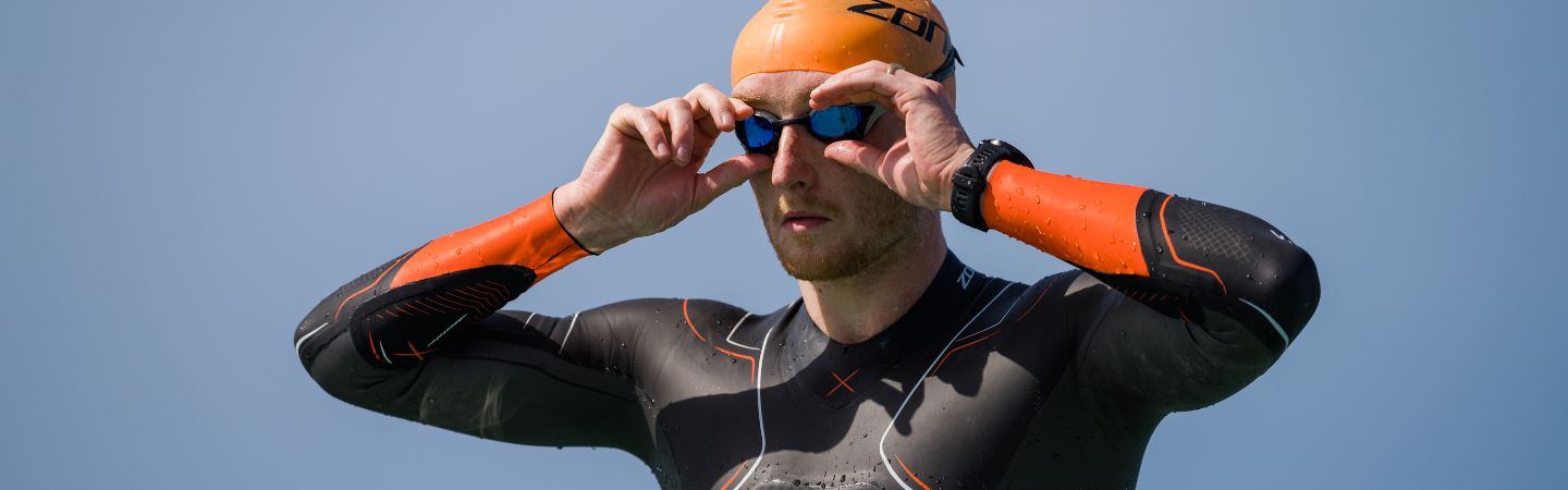 Harry Palmer professional triathlete wearing the vanquish x wetsuit , orange swim cap and volare goggles