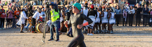 marta sanchez in running into the water for a ironman swim start wearing her zone3 wetsuit