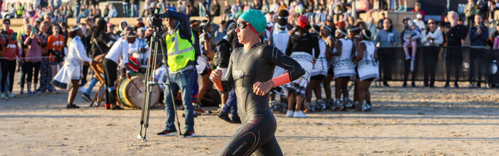 marta sanchez in running into the water for a ironman swim start wearing her zone3 wetsuit