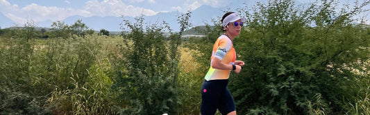 Norma Coker is running on the road in her ZONE3 pro team trisuit 