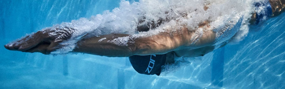 a man is diving into the swimming pool