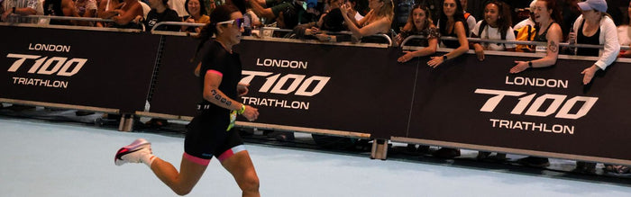 a girl is running down the finish line of the T100