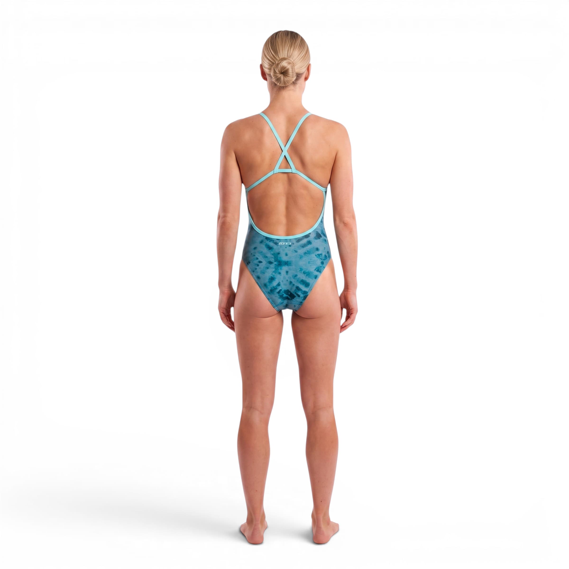 athlete wearing the Zone3 strap back swimsuit in teal. back facing on a white background. 