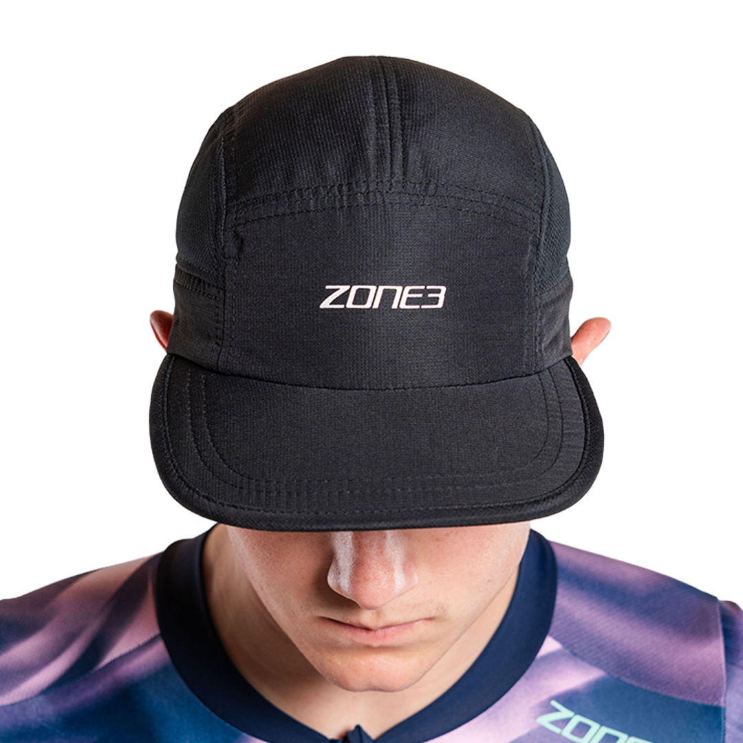 Person wearing black panel running cap with zone3 logo on a white background
