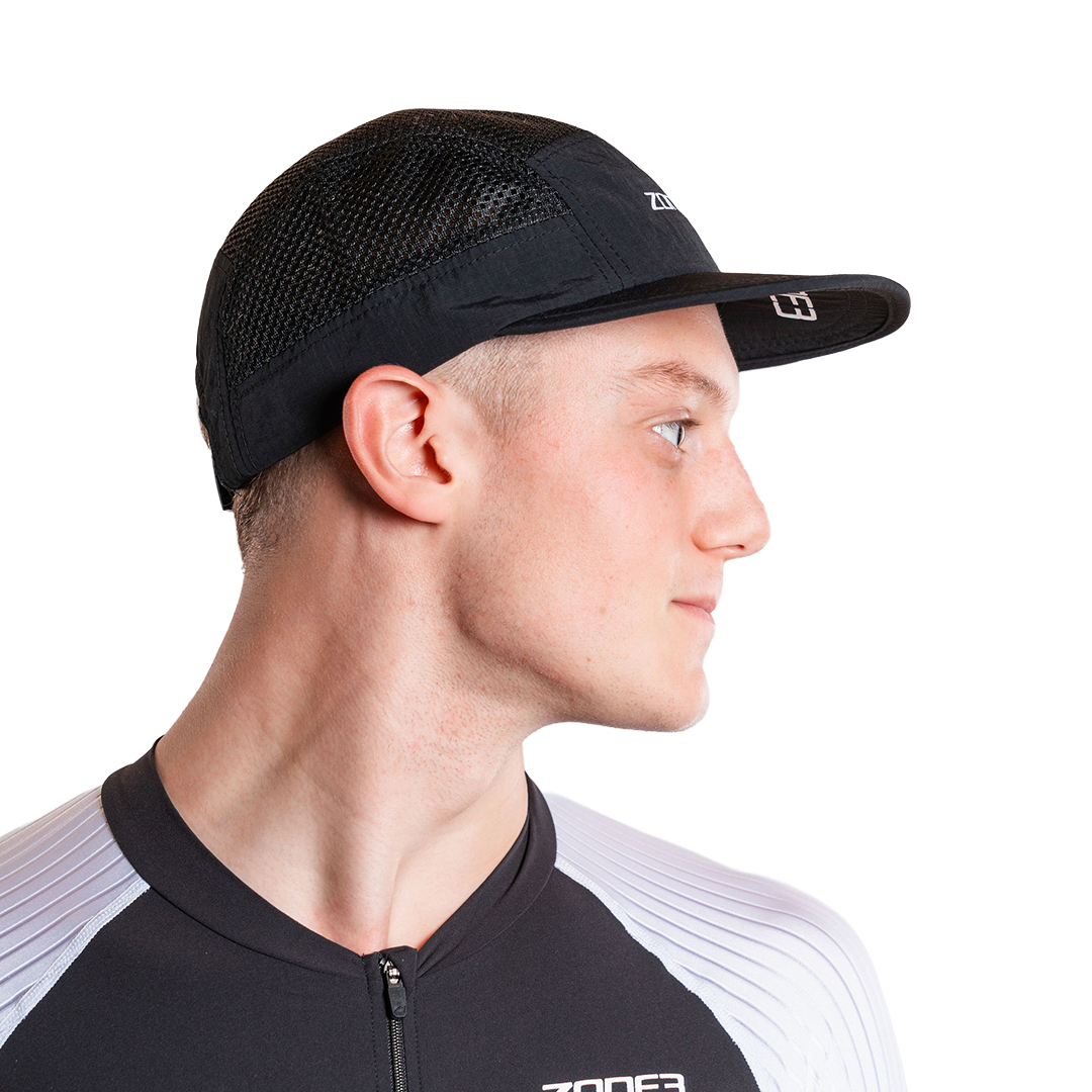 Man wearing a black mesh panel with a zone3 logo on a white background