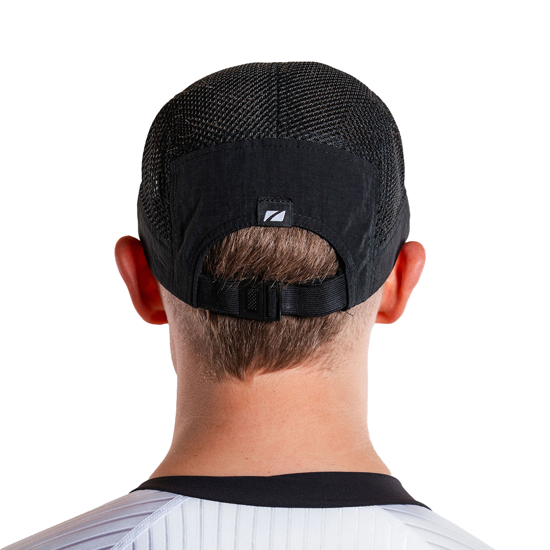 Black mesh cap worn backwards on a person's head with a visible zone3 go.