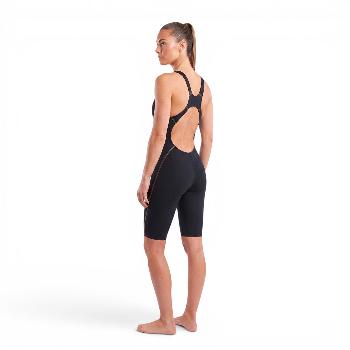 A woman wearing the Zone3 MF-X Performance Gold FINA kneeskin on a white background.