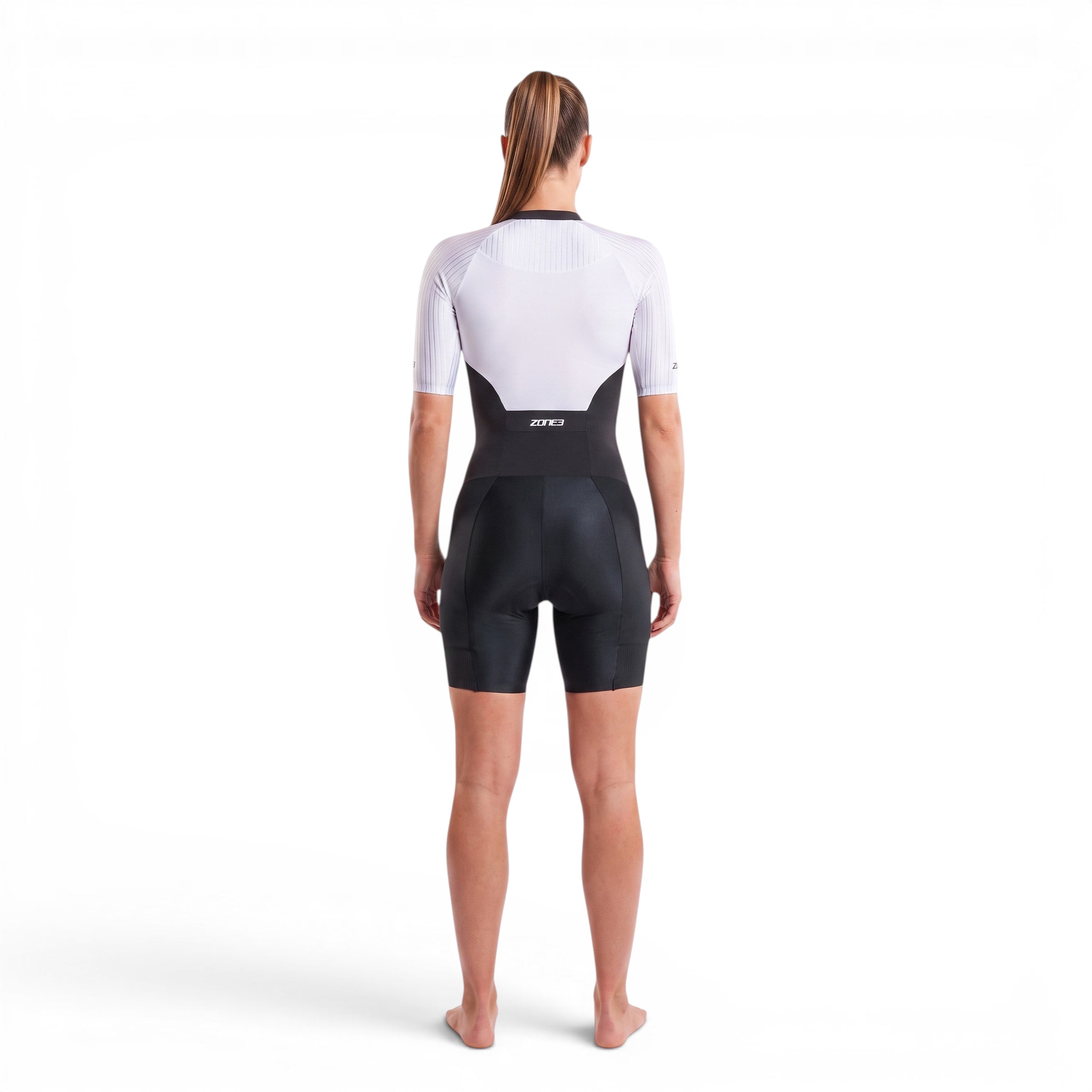 A woman wearing the Zone3 Lava full zip short sleeve trisuit on a white background.