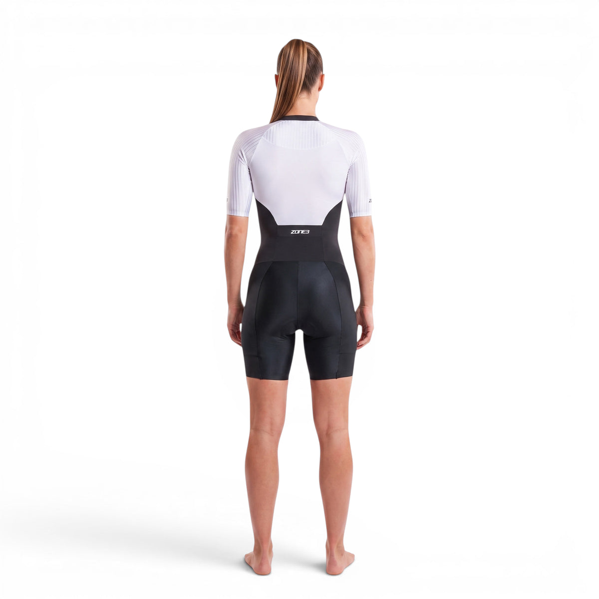 A woman wearing the Zone3 Lava full zip short sleeve trisuit on a white background.