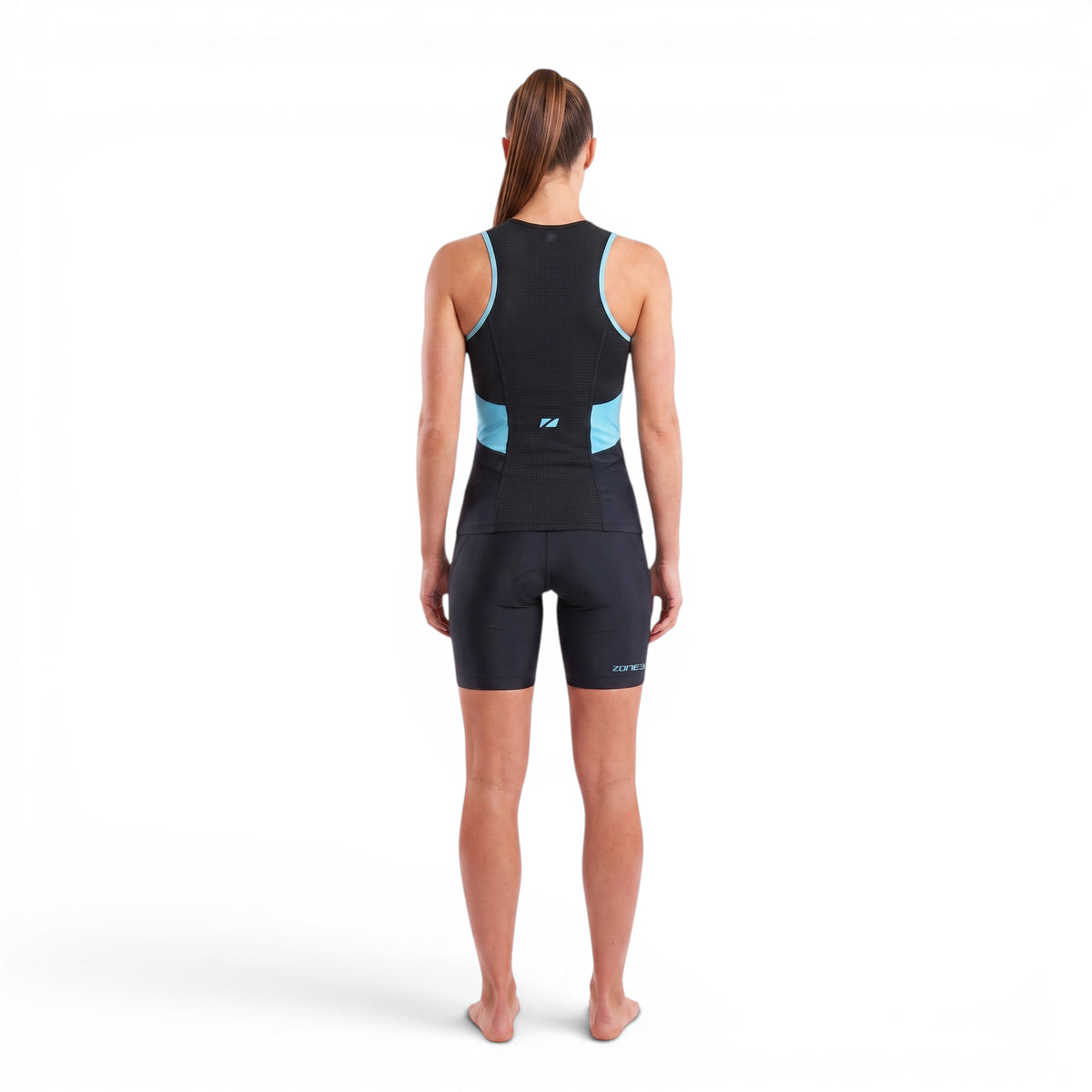 A woman wearing the Zone3 Activate tri top and shorts in black with blue detailing on a white background.