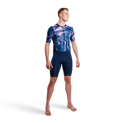 Person wearing a purple and pink trisuit on a white background