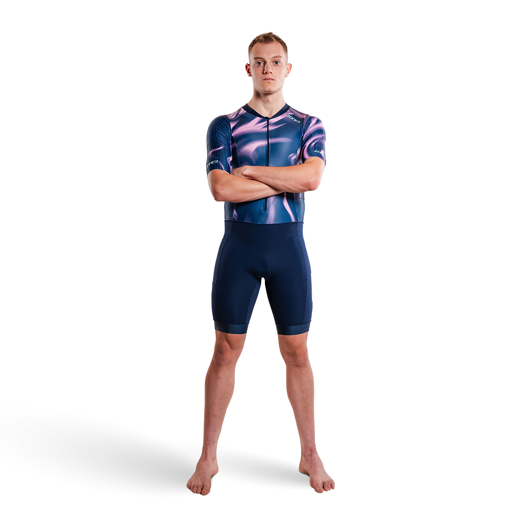 Person wearing a purple and pink trisuit on a white background