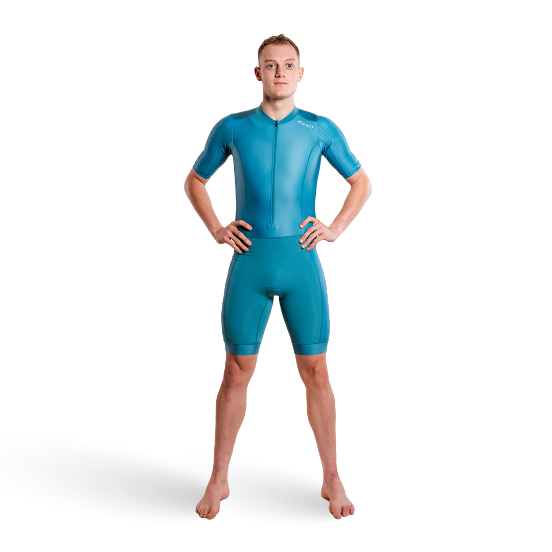 Person wearing a teal trisuit on a white background