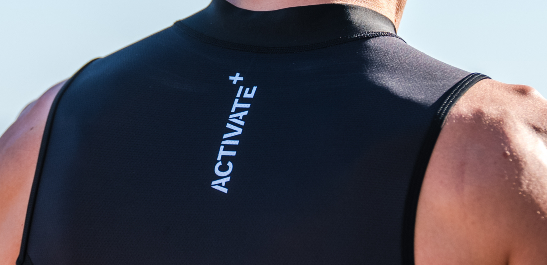 Close up of zone3 black activate+ sleeveless trisuit on a blurred background