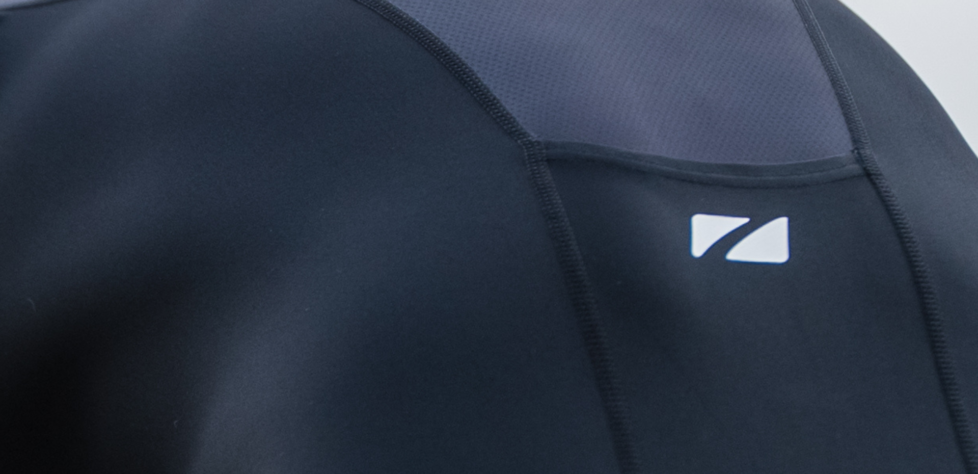 Close up of zone3 black activate+ sleeveless trisuit on a blurred background
