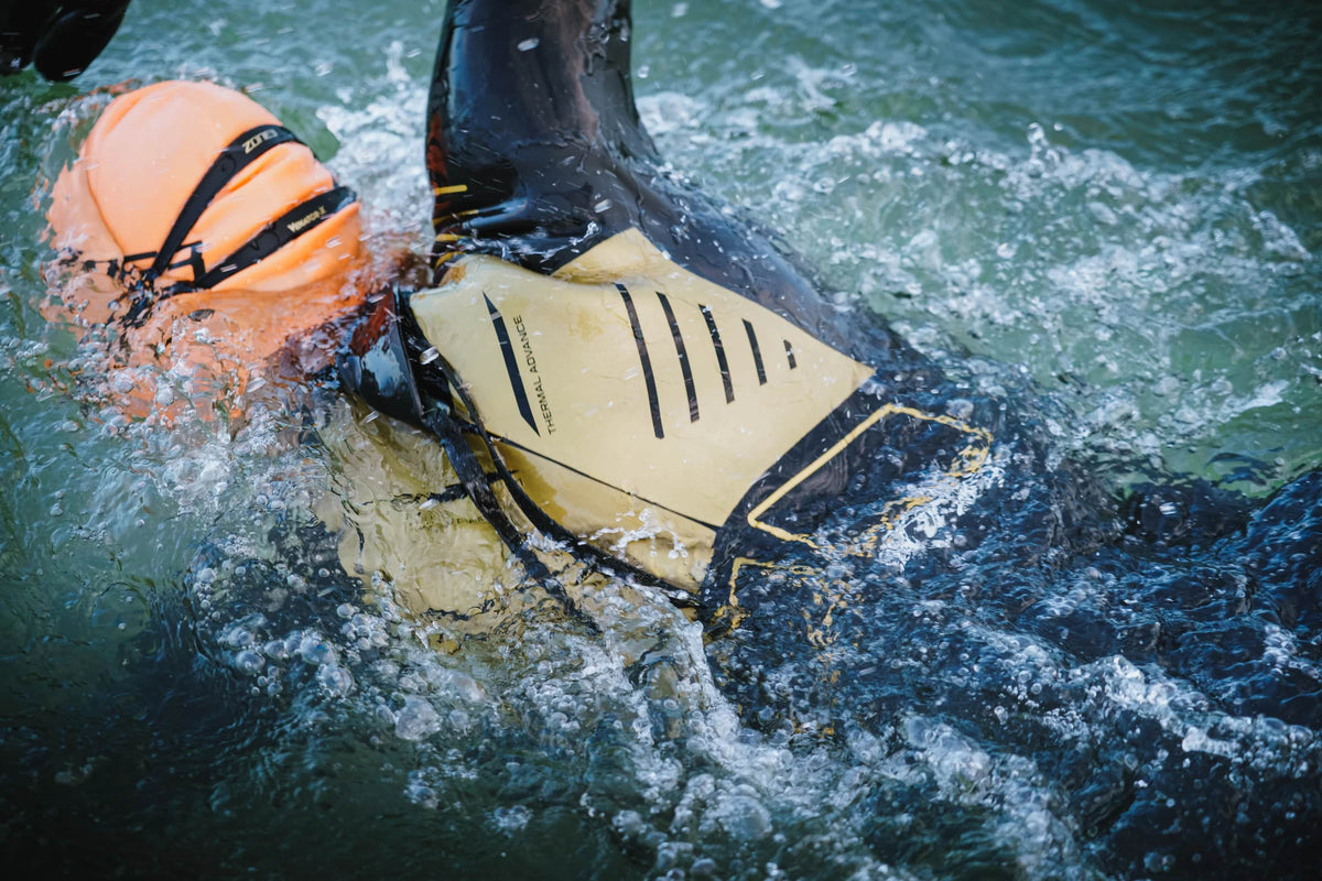 close up of the back panel of the Zone3 Advance thermal wetsuit. Athlete swimming in open water.