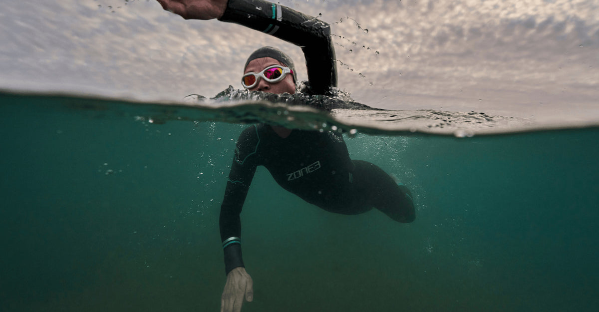 Athlete swimming in open water wearing the Zone3 Advance wetsuit. 