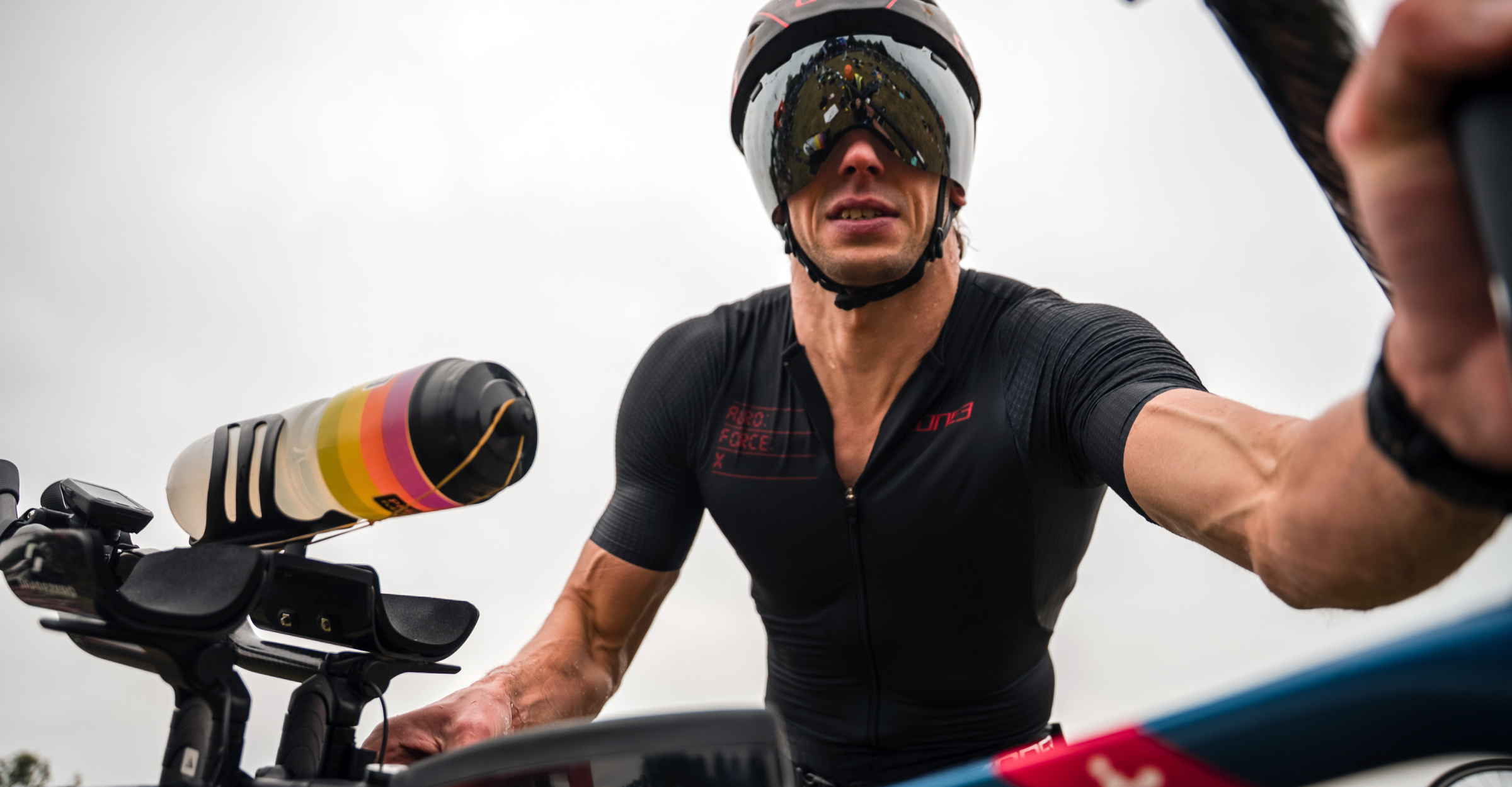 Man wearing zone3 Aeroforce-X Trisuit at a race event with a helmet 