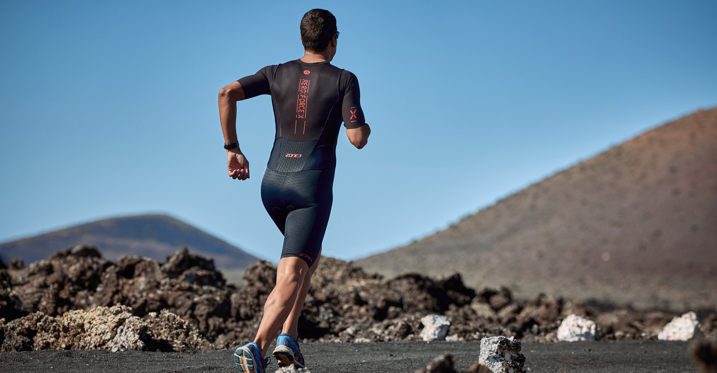 Man wearing zone3 Aeroforce-X Trisuit running on a blurred background