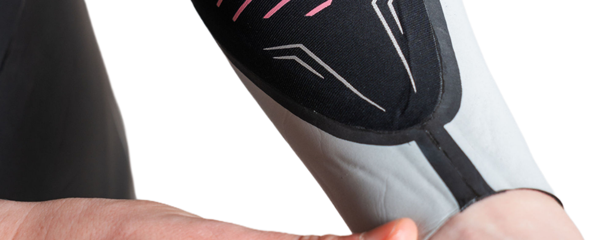 Close-up of a person holding a white and black device with pink accents.