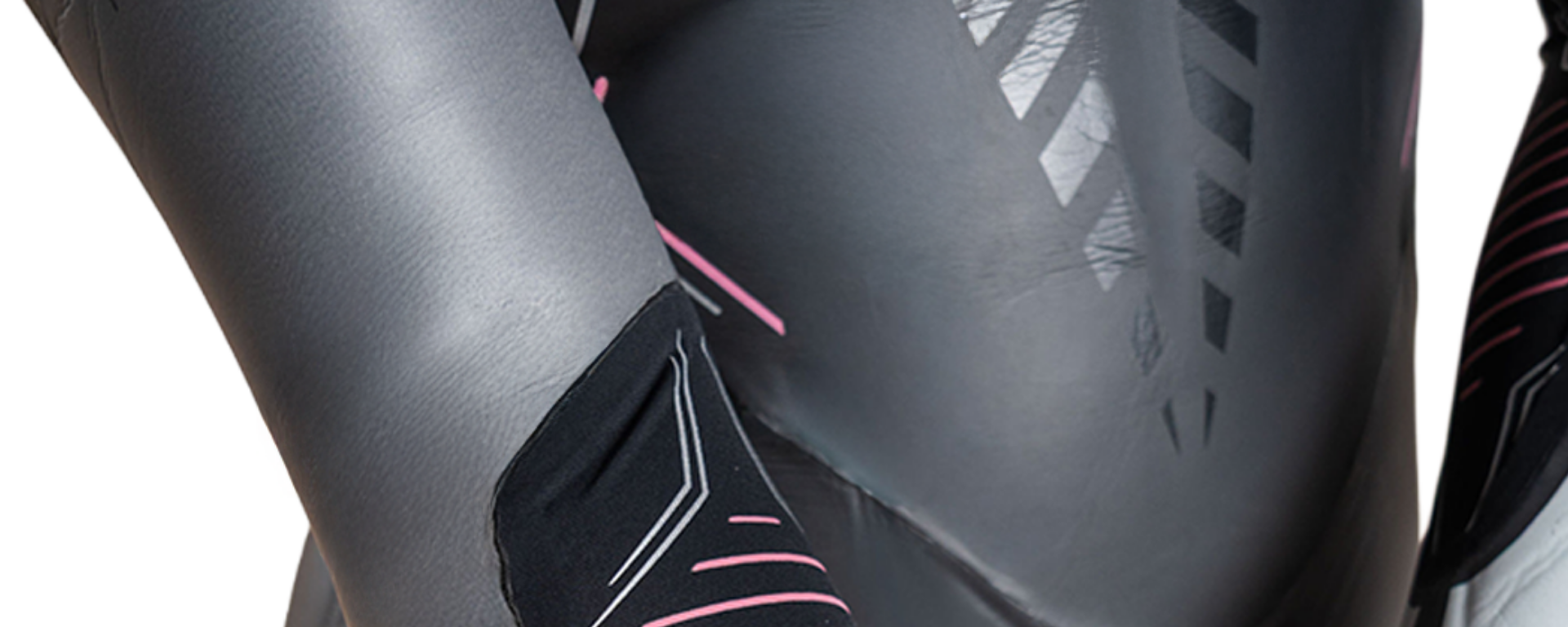 Close-up of a black and gray motorcycle seat with pink accents on a white background