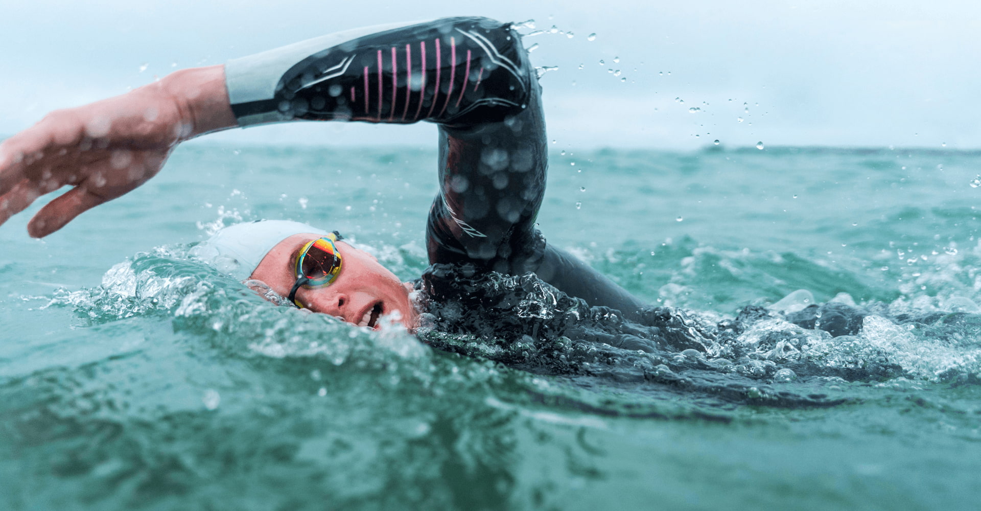 Athlete wearing the Zone3 Aspire wetsuit in open water. 