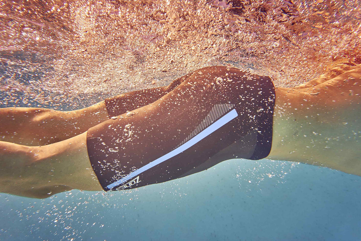 Athlete swimming wearing the Buoyancy Shorts - The Originals : 5/3mm. 