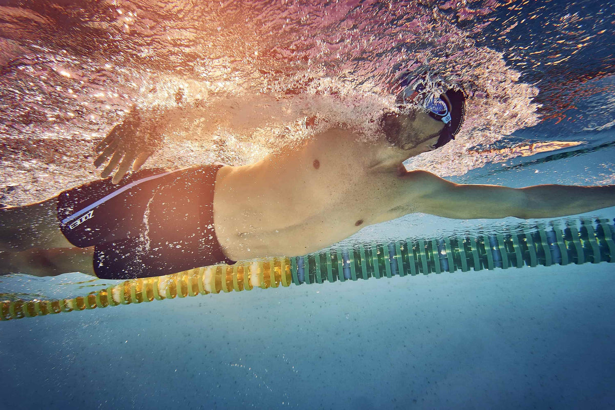 athlete swimming in a pool wearing the Zone3 Buoyancy Shorts - The Originals : 5/3m 