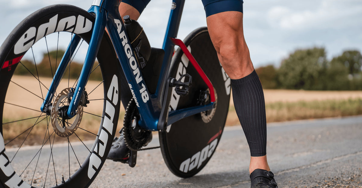 athlete wearing the Zone3 Calf Sleeve. blurred background 