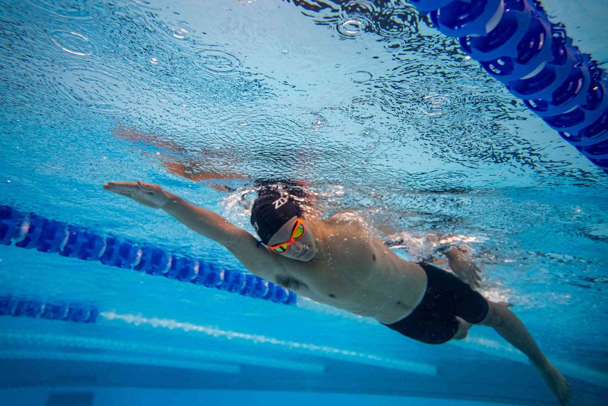 Athlete wearing the Zone3 FINA Approved Men's Performance Gold Jammers in the pool. 