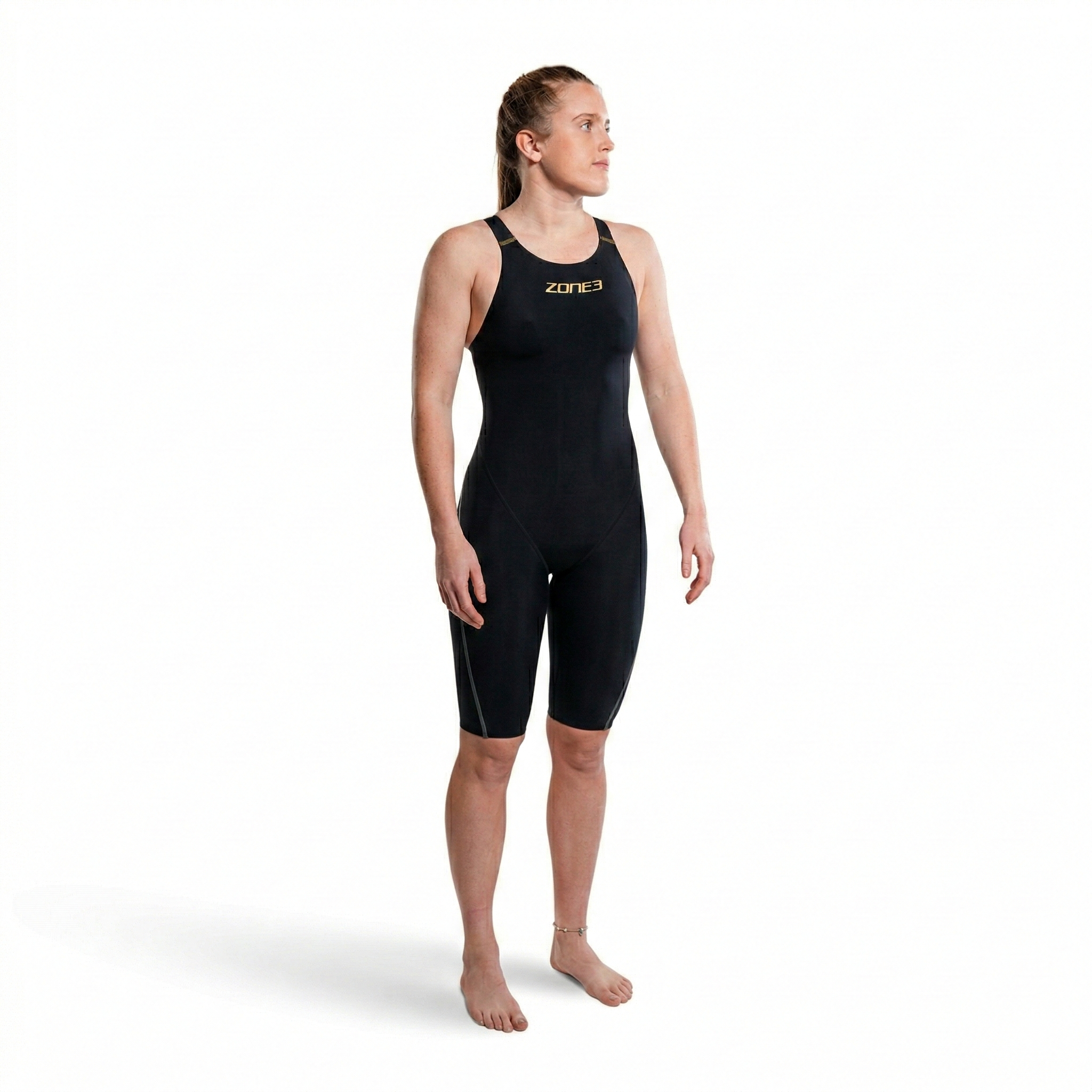 Back view of a female swimmer in a black MF-X Kneeskin with open back and gold detailing on the straps.