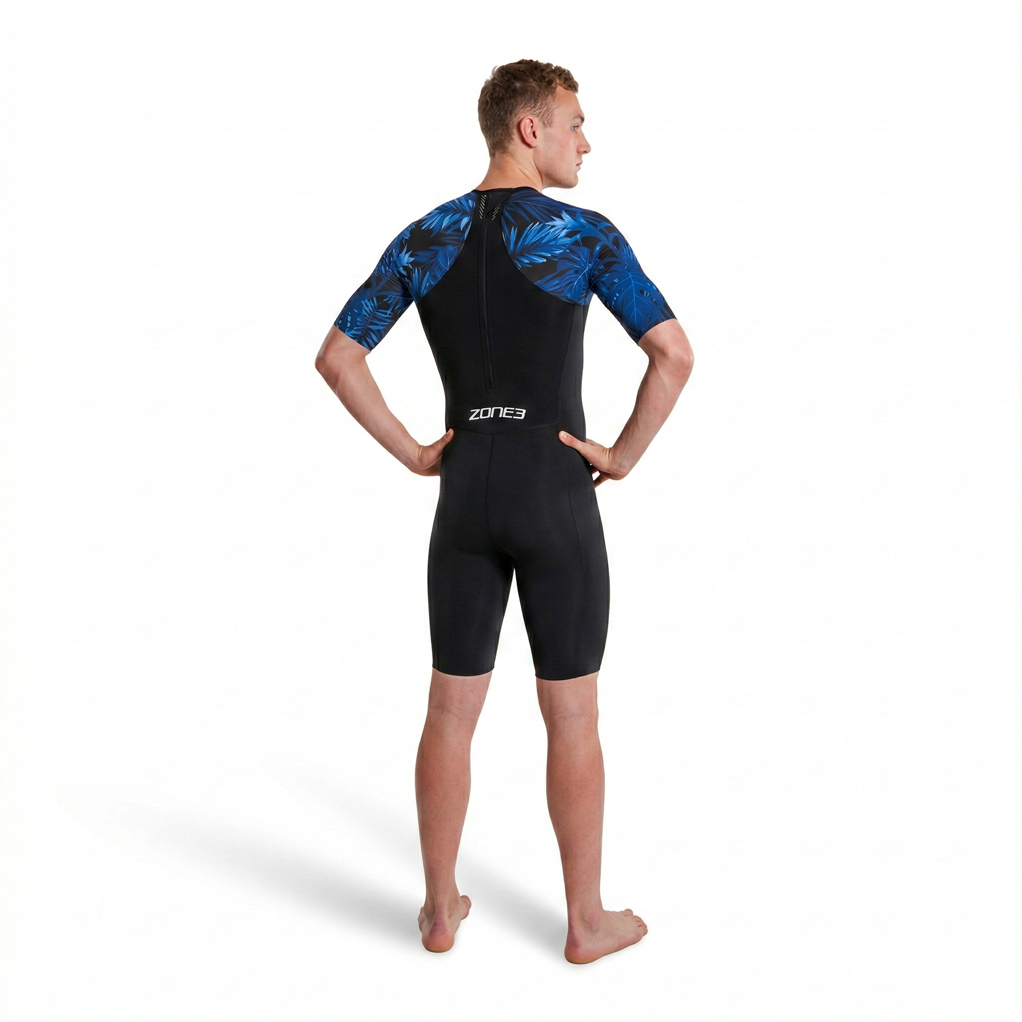 Person wearing a black and blue wetsuit with 'Zone3' branding on a white background