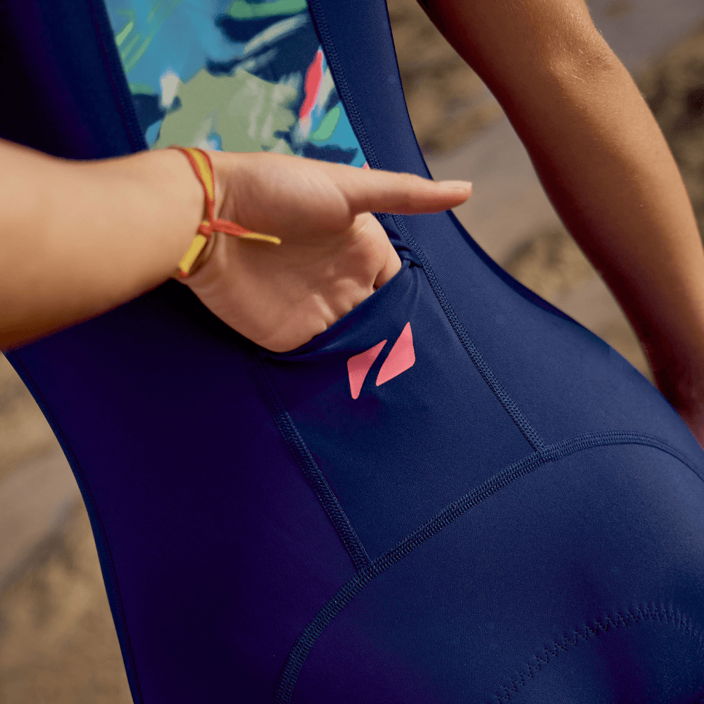 close up of  a junior wearing the Zone3 print trisuit from the back showing the pocket available. 