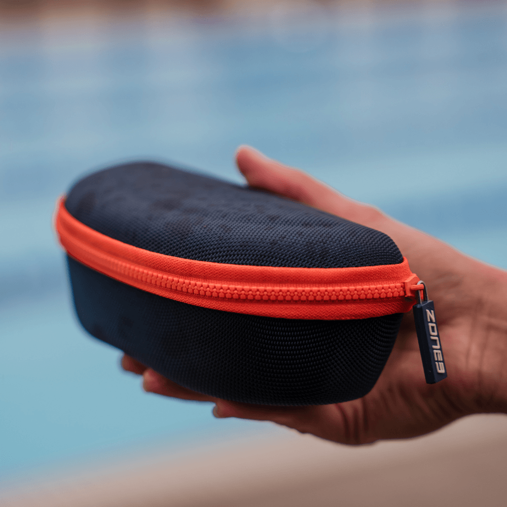 closed Navy blue and orange case with Zone3 logo. blurred pool background.