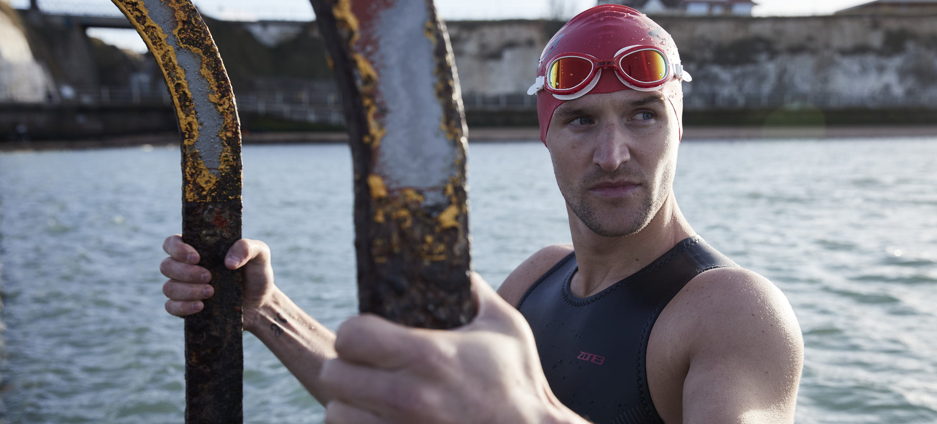 athlete getting out of open water wear Zone3 gear and red attack goggles 