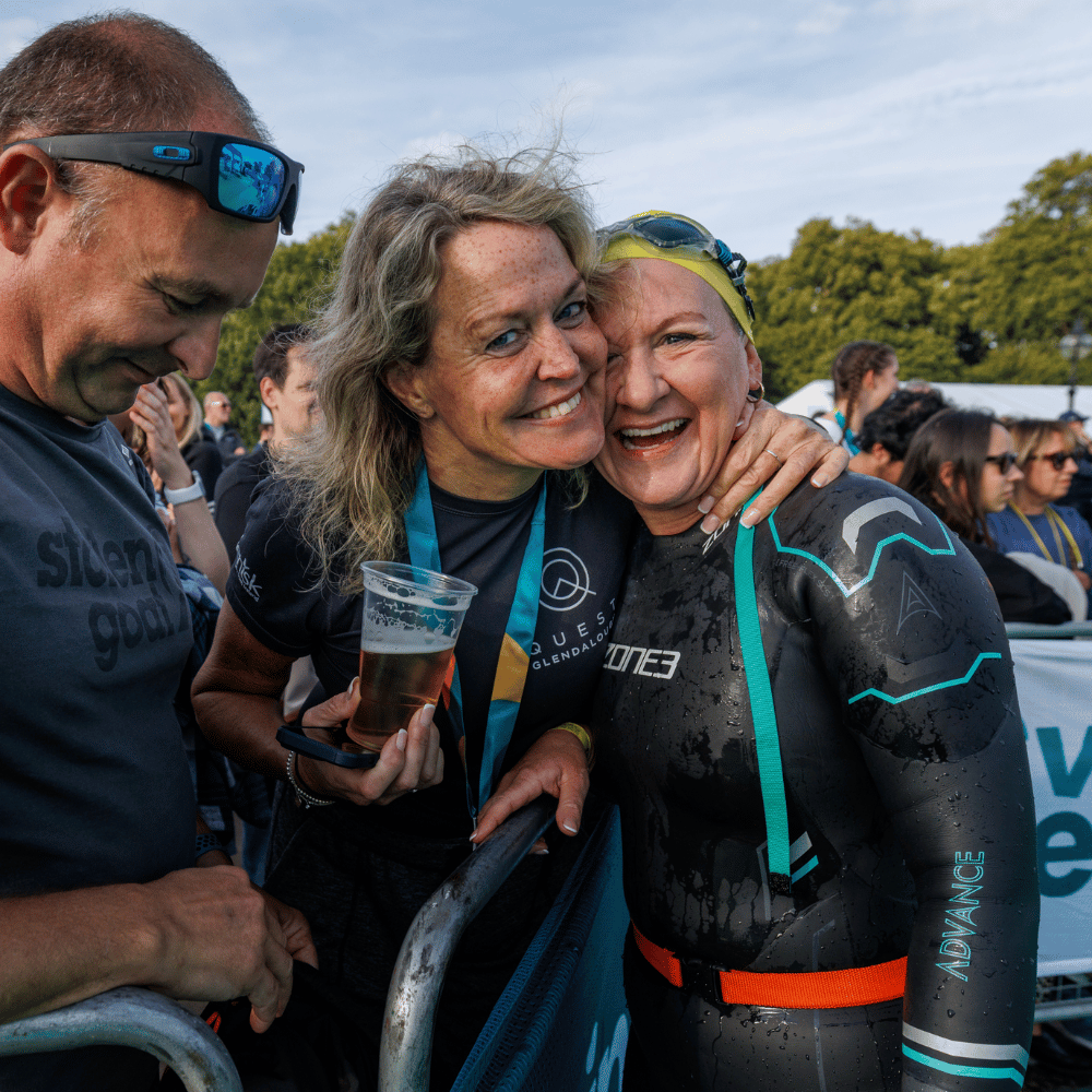 Two ladies posing for a photo after the swim serpentine finish line. The lady on the right is wearing a ZONE3 Advance wetsuit. 