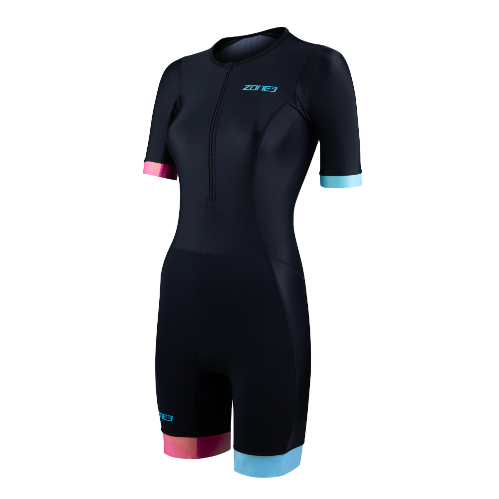 Front view of the ZONE3 Activate+ women’s short sleeve trisuit in black, featuring a blue ZONE3 logo, front zip, and pink and blue sleeve and leg cuffs.