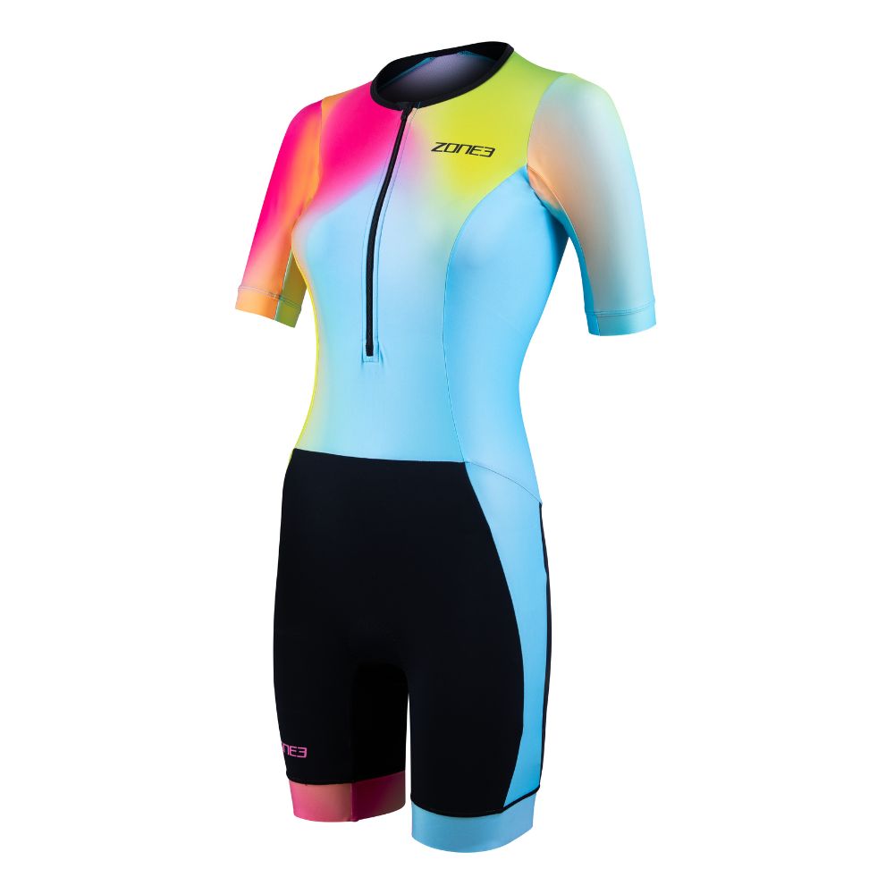 Front view of the ZONE3 Activate+ women’s short sleeve trisuit with a gradient design in pink, yellow, and blue. Features a front zip and black shorts section.