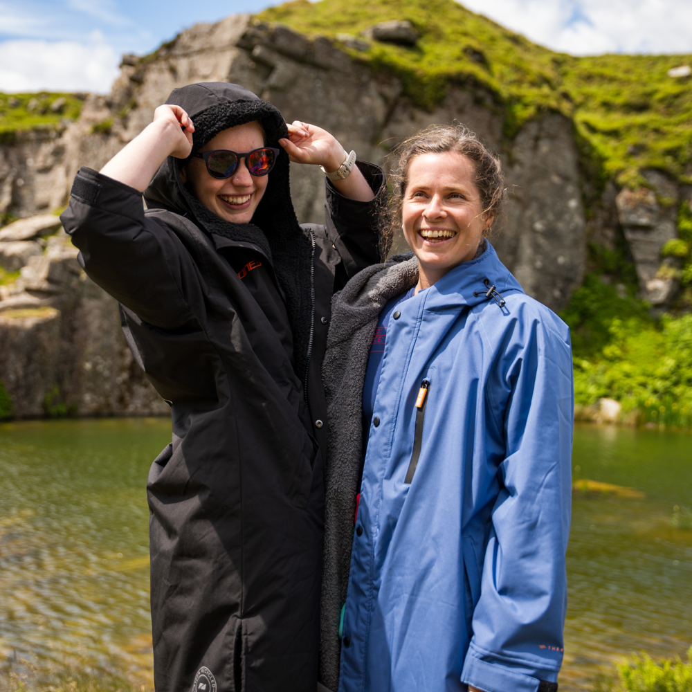 Front view of person wearing Active-Flex changing robe next to another person wearing a thermotech changing robe in blue