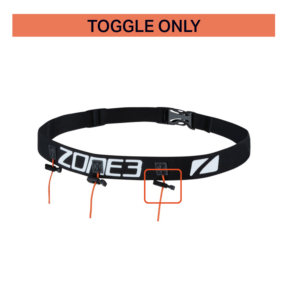 Close-up of Zone3 race belt toggle component, highlighted on a black adjustable belt with white Zone3 branding and orange elastic cords. Image focuses on replacement toggle part, available for UK addresses only.