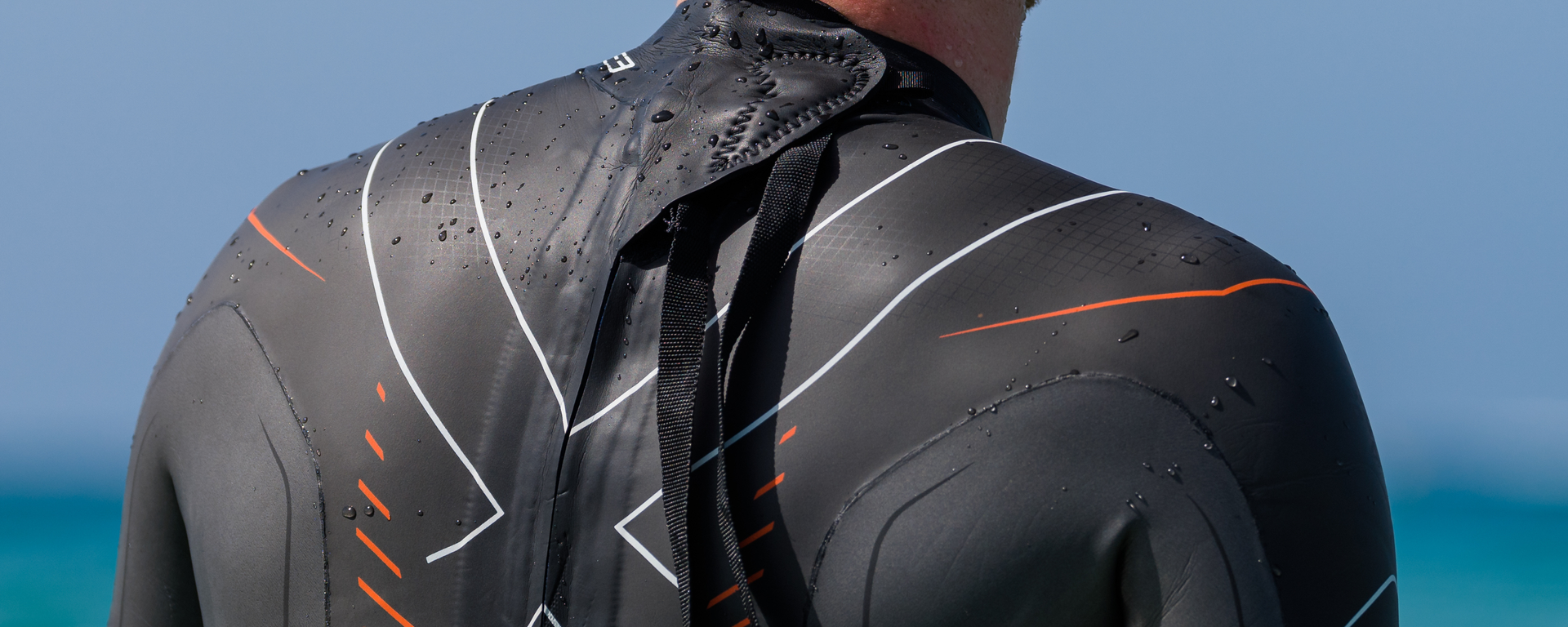 close up of the Titanium lining on the upper body of a man wearing the Vanquish-X wetsuit from the back.  