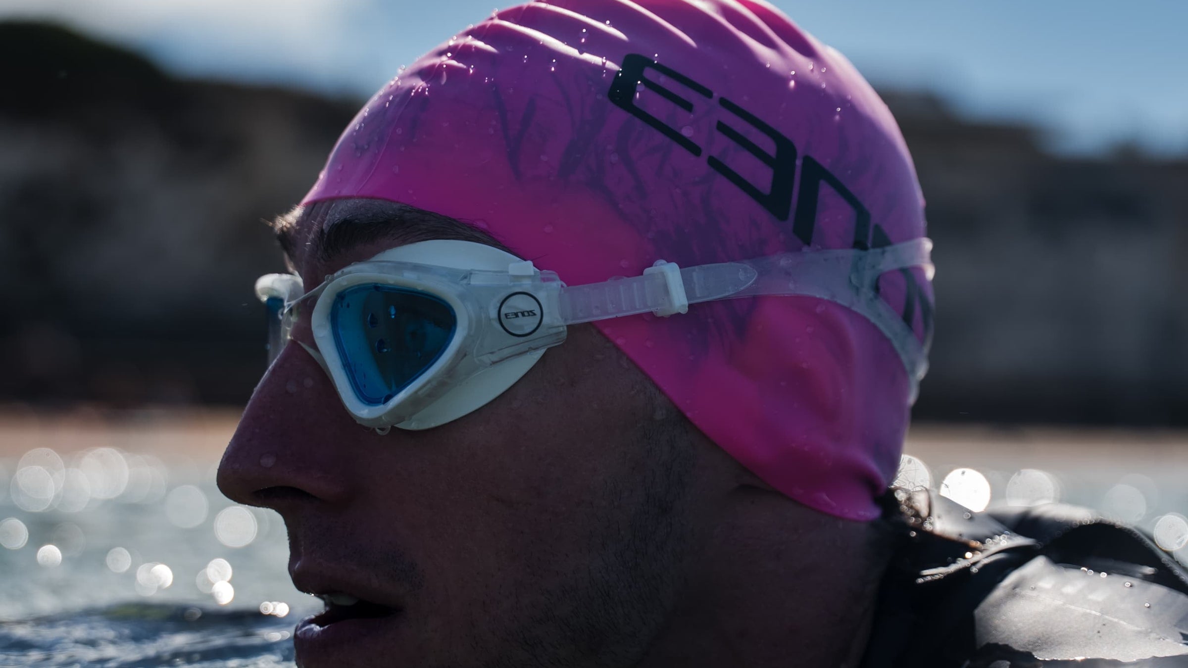 close up of an athlete wearing Zone3 Vapour goggles in blue clear in open water 