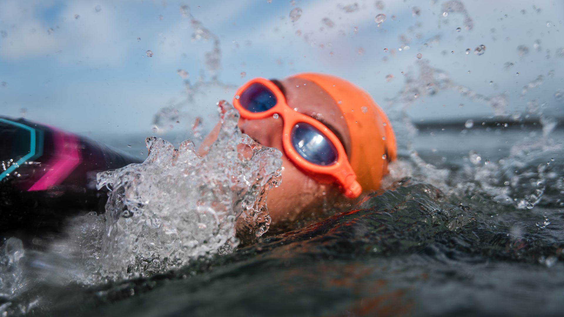 Athlete wearing Zone3 Venator-X goggles in open water swimming 