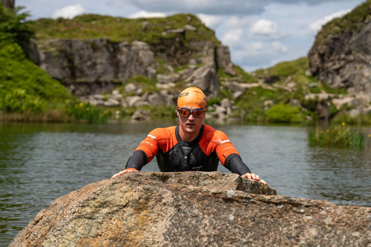 Athlete wearing the Zone3 Versa swimrun wetsuit in open water. 