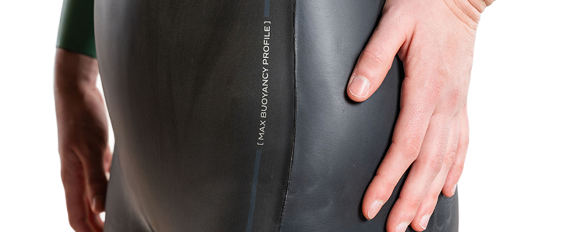 Person holding a black wetsuit with 'Max Buoyancy Profile' text on a white background