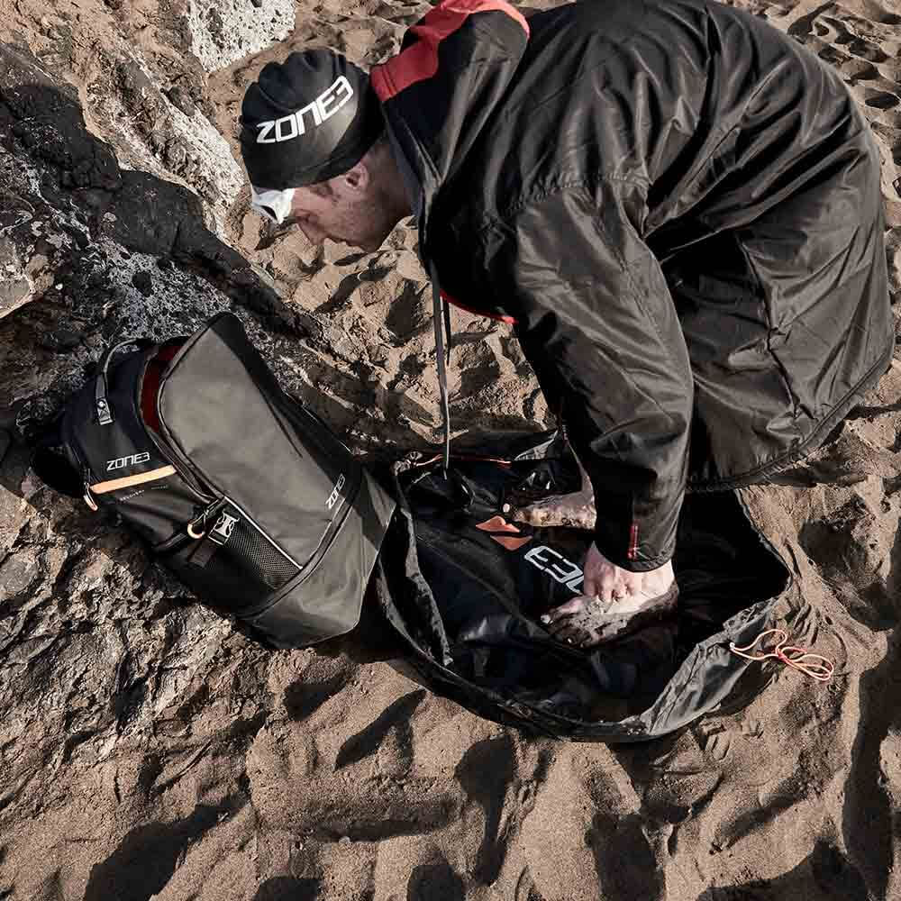 Athlete using the Zone3 wetsuit Changing mat at the beach. 