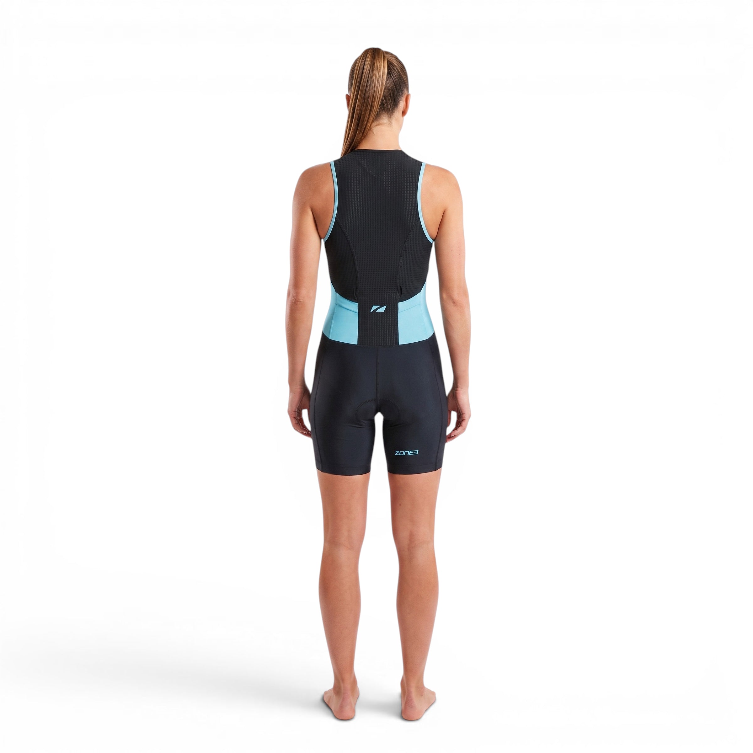 A woman wearing the Zone3 Activate trisuit in black with blue detailing. showing the trisuit from the back side on a white background.